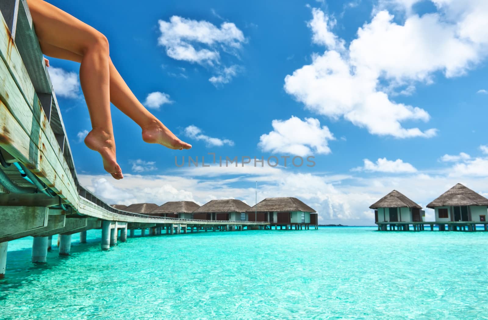 Woman's legs at beach jetty