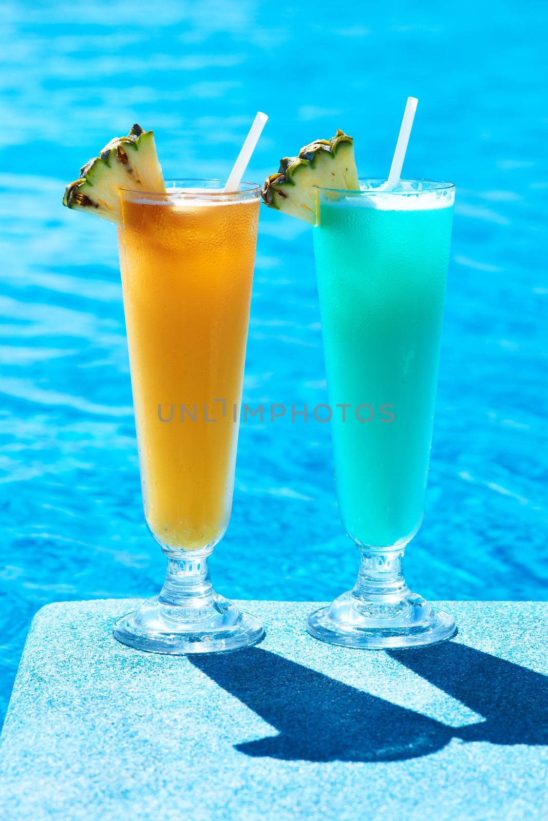 Cocktails near swimming pool by haveseen