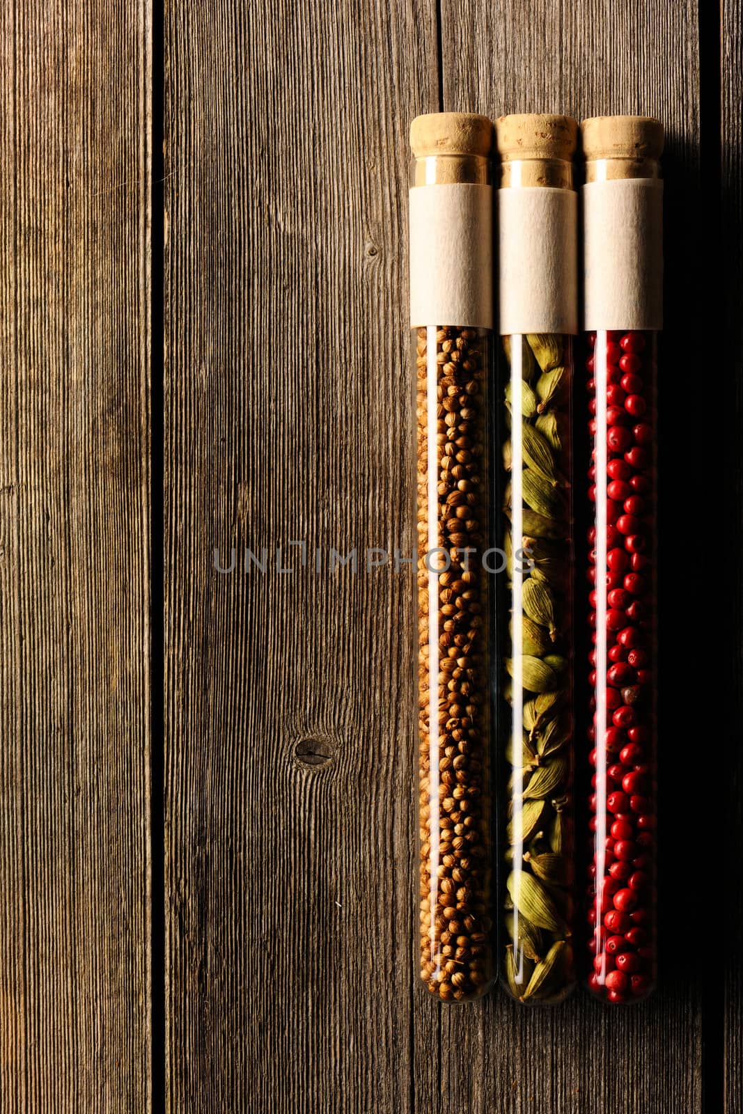 Spices in beakers on wooden background