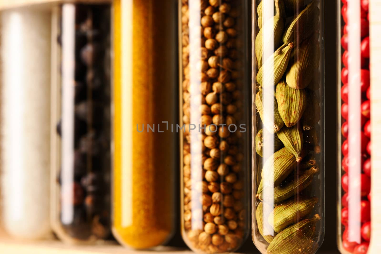 Spices in beakers against dark background