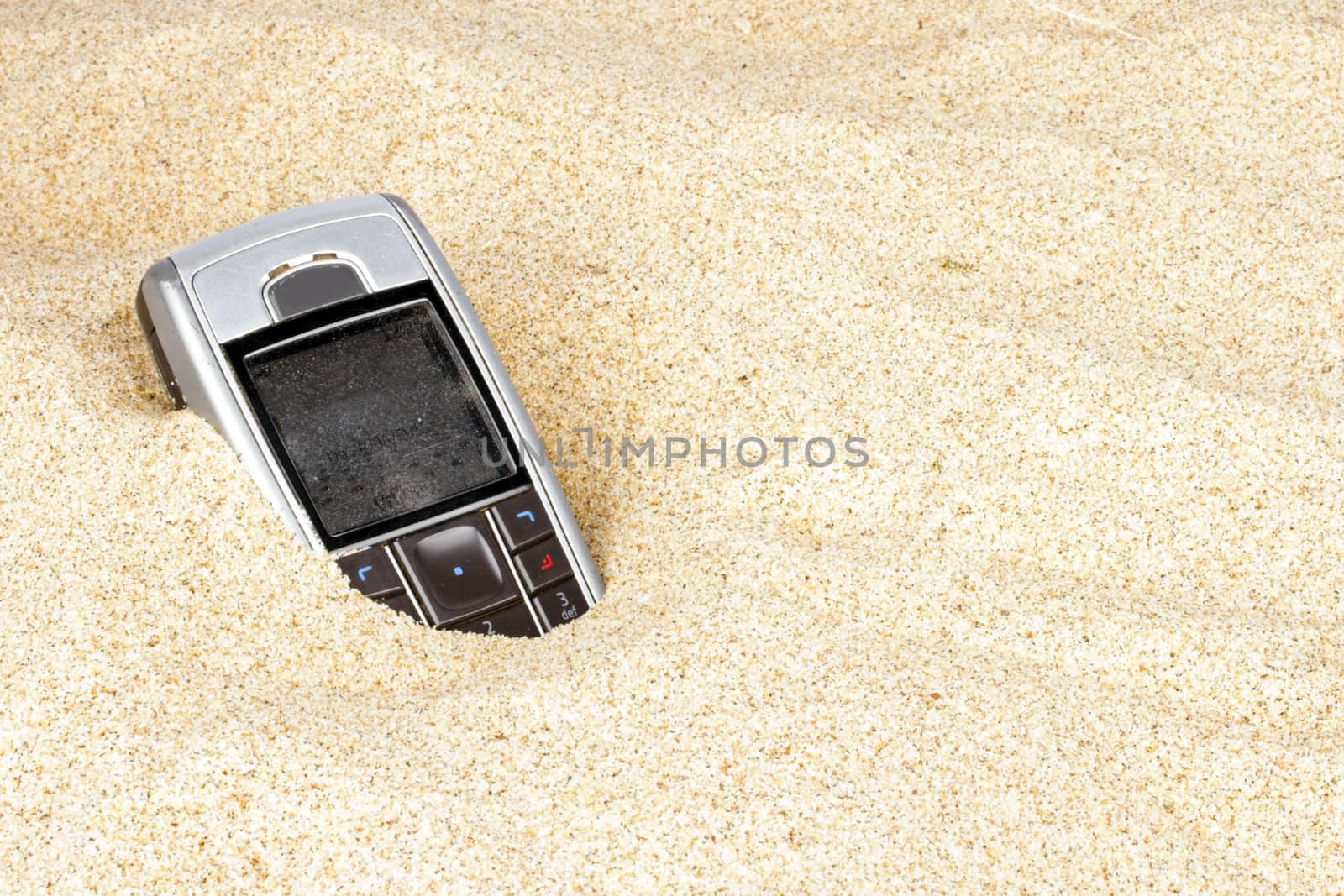 Mobile phone in the sand