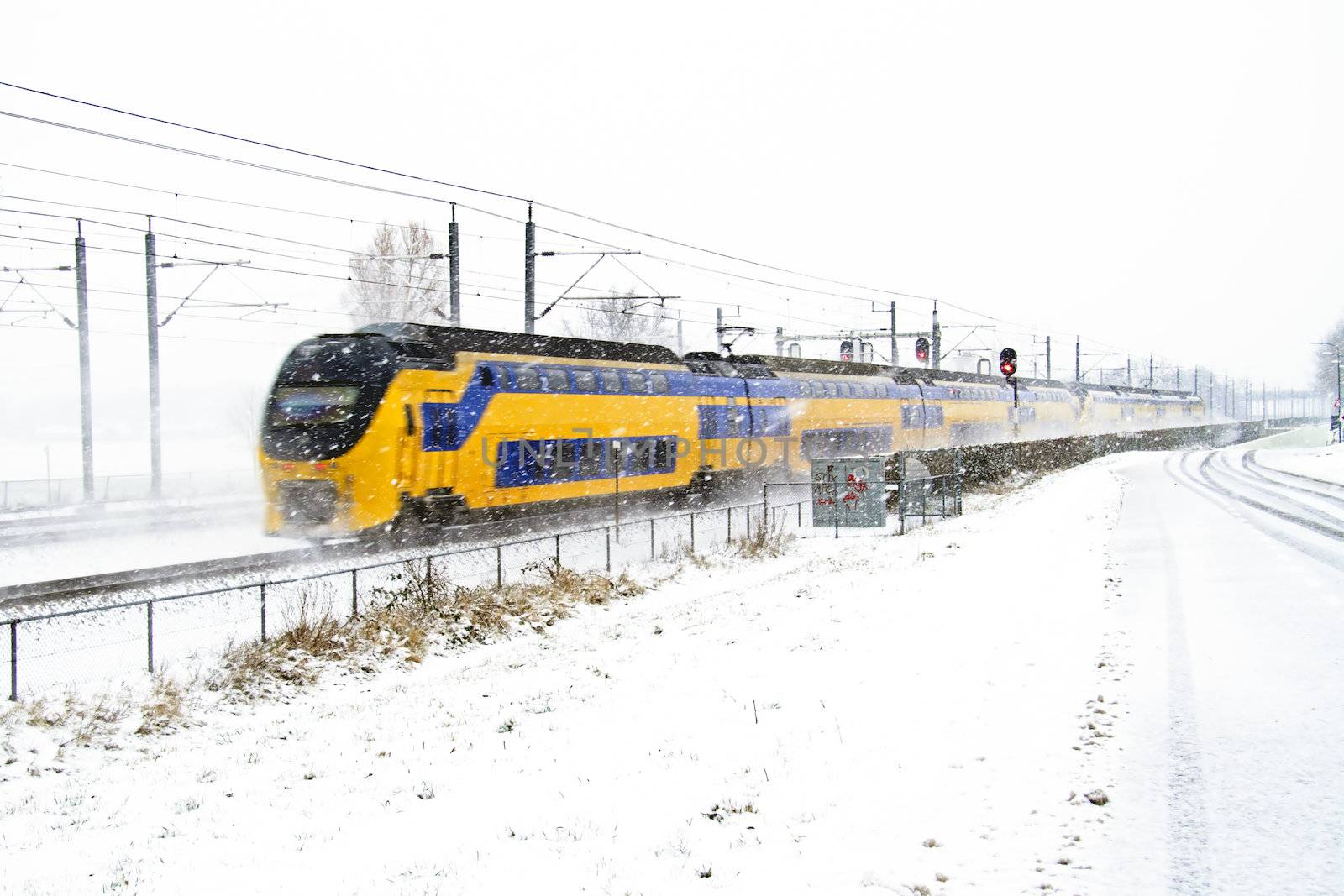 Train driving in a snowstorm in the Netherlands
