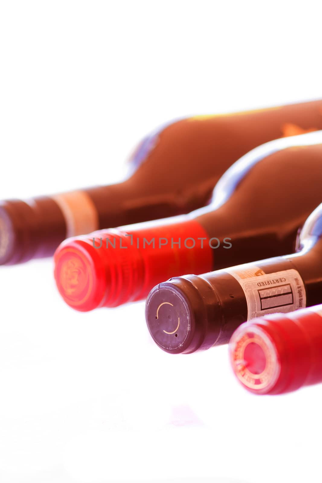 Four Bottles of red wine isolated on a white background