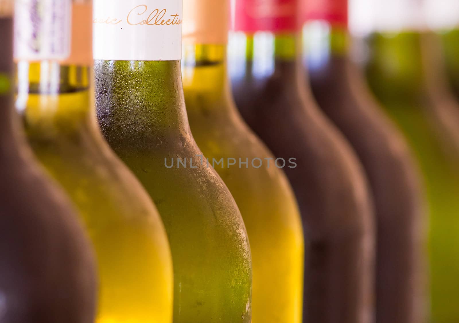 Various Bottles of Wine stacked next to each other