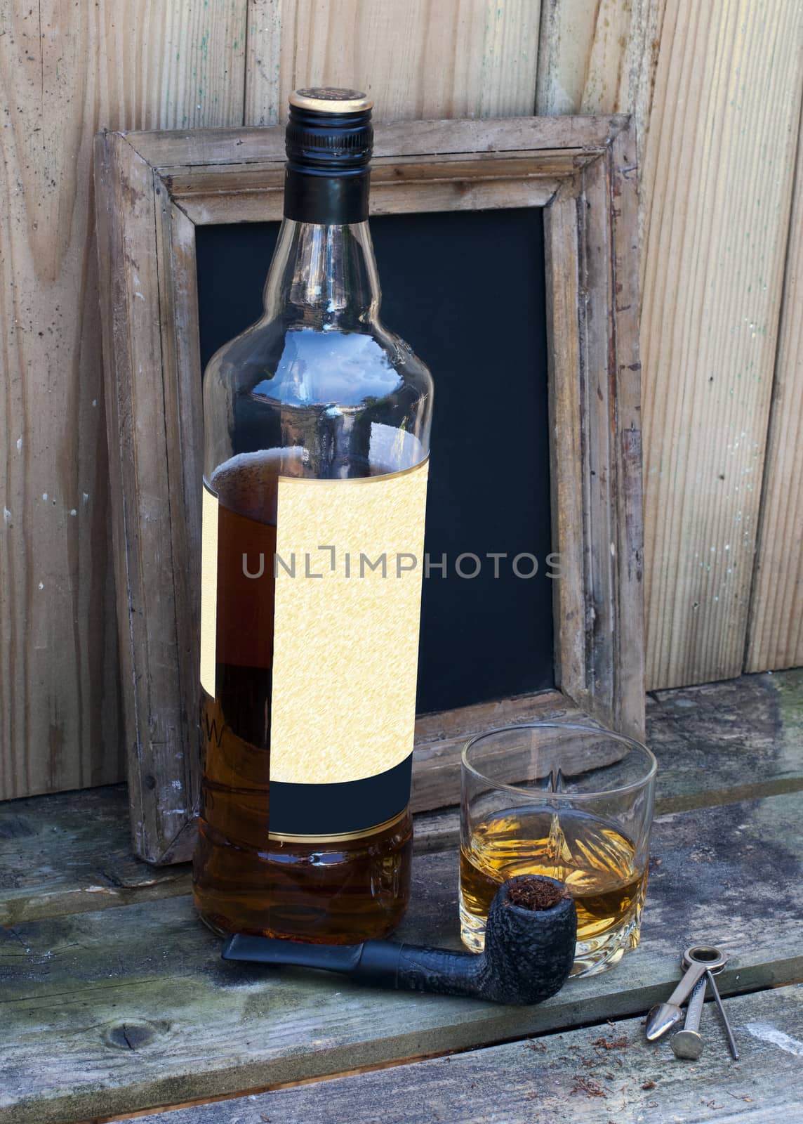still life with bottle of whiskey and a glass