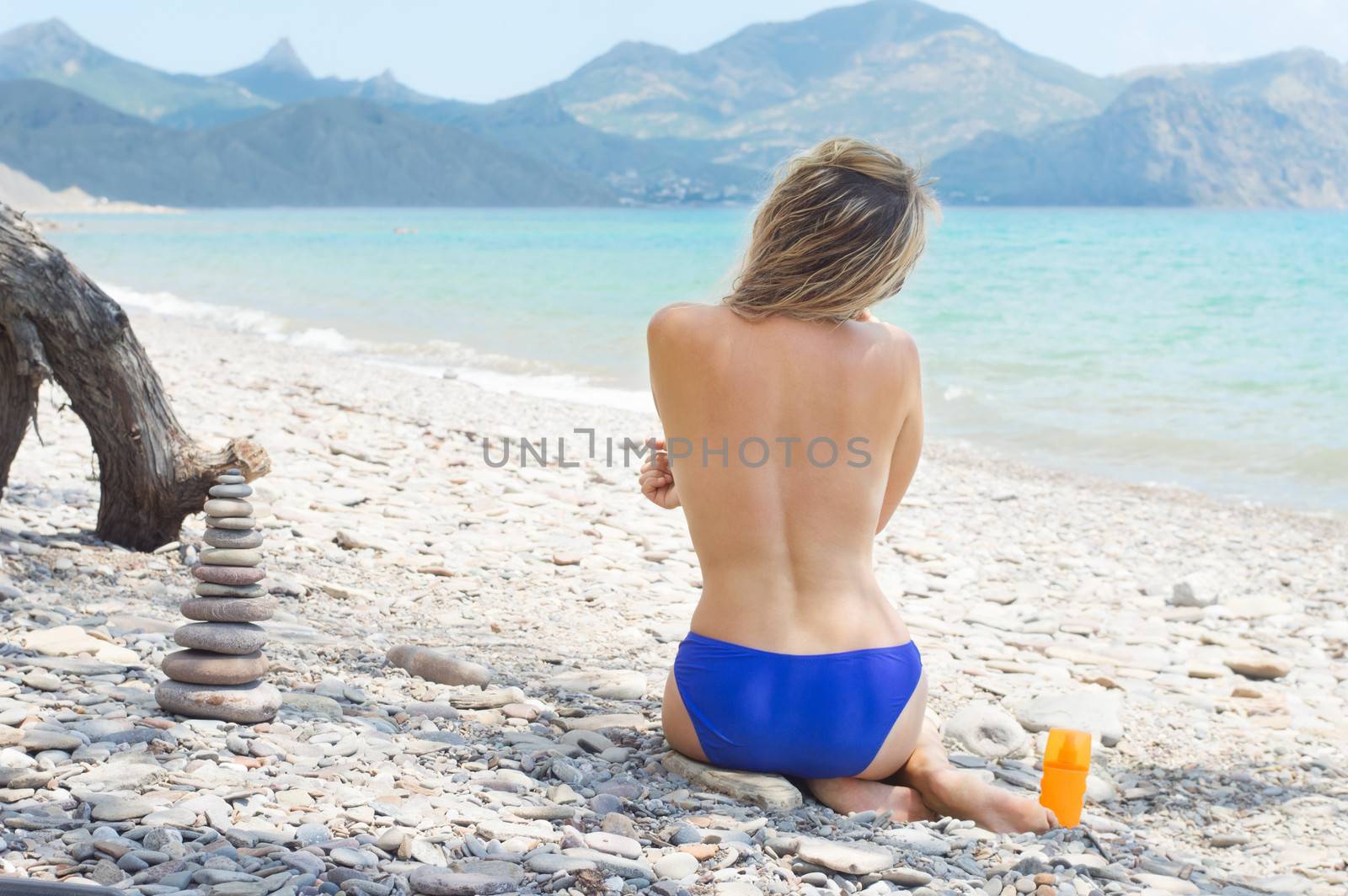 girl sunbathe on the beach by gurin_oleksandr