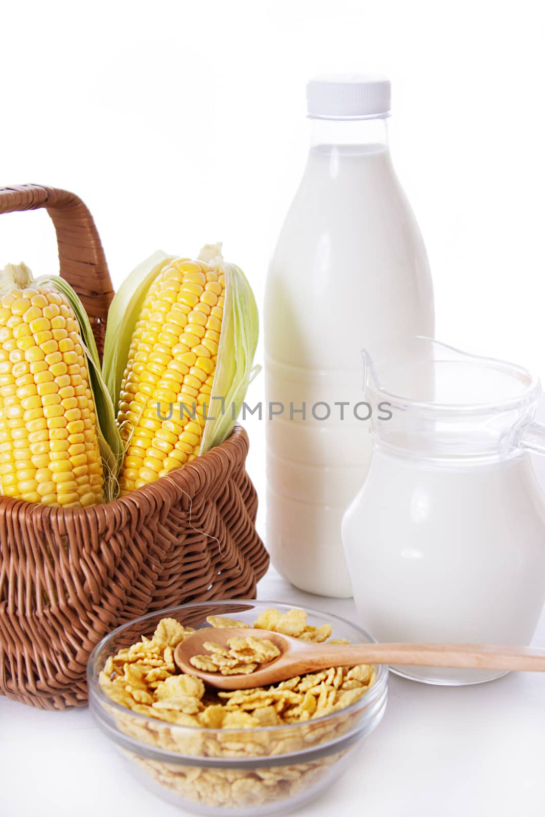 Bottle and jar of milk with corn and flakes isolated on white