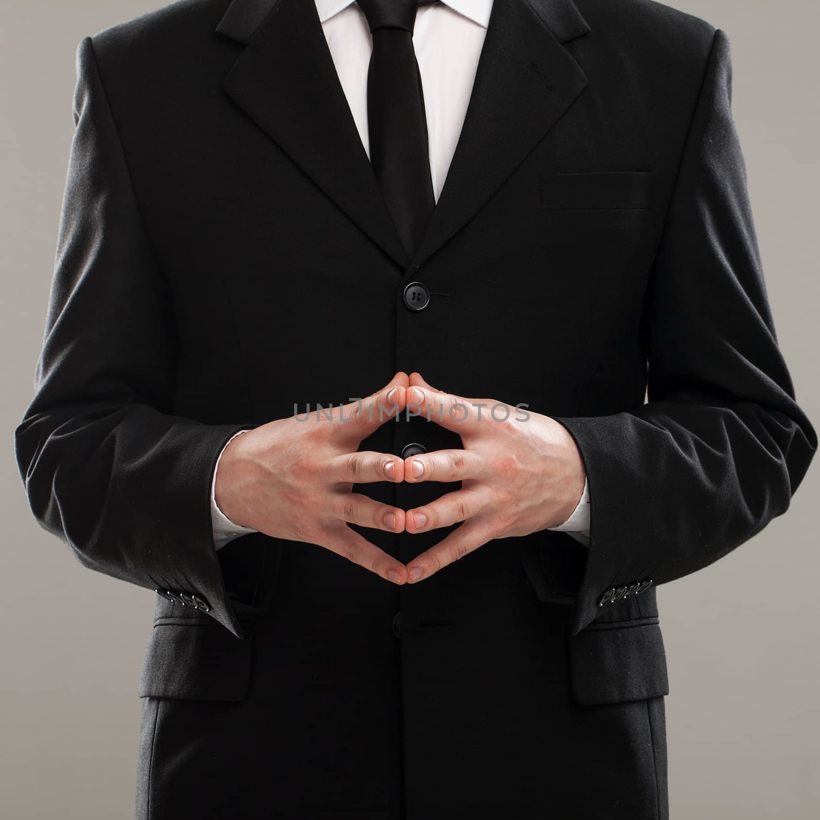 Businessman's torso in suit over grey background