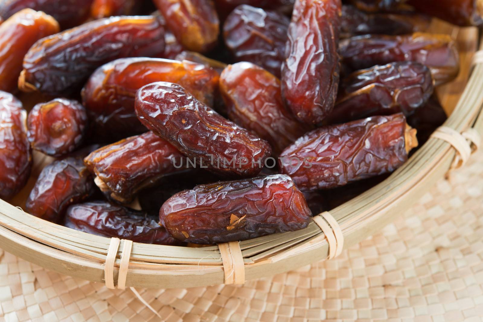 Dates fruit. Pile of fresh dried date fruits in a basket.
