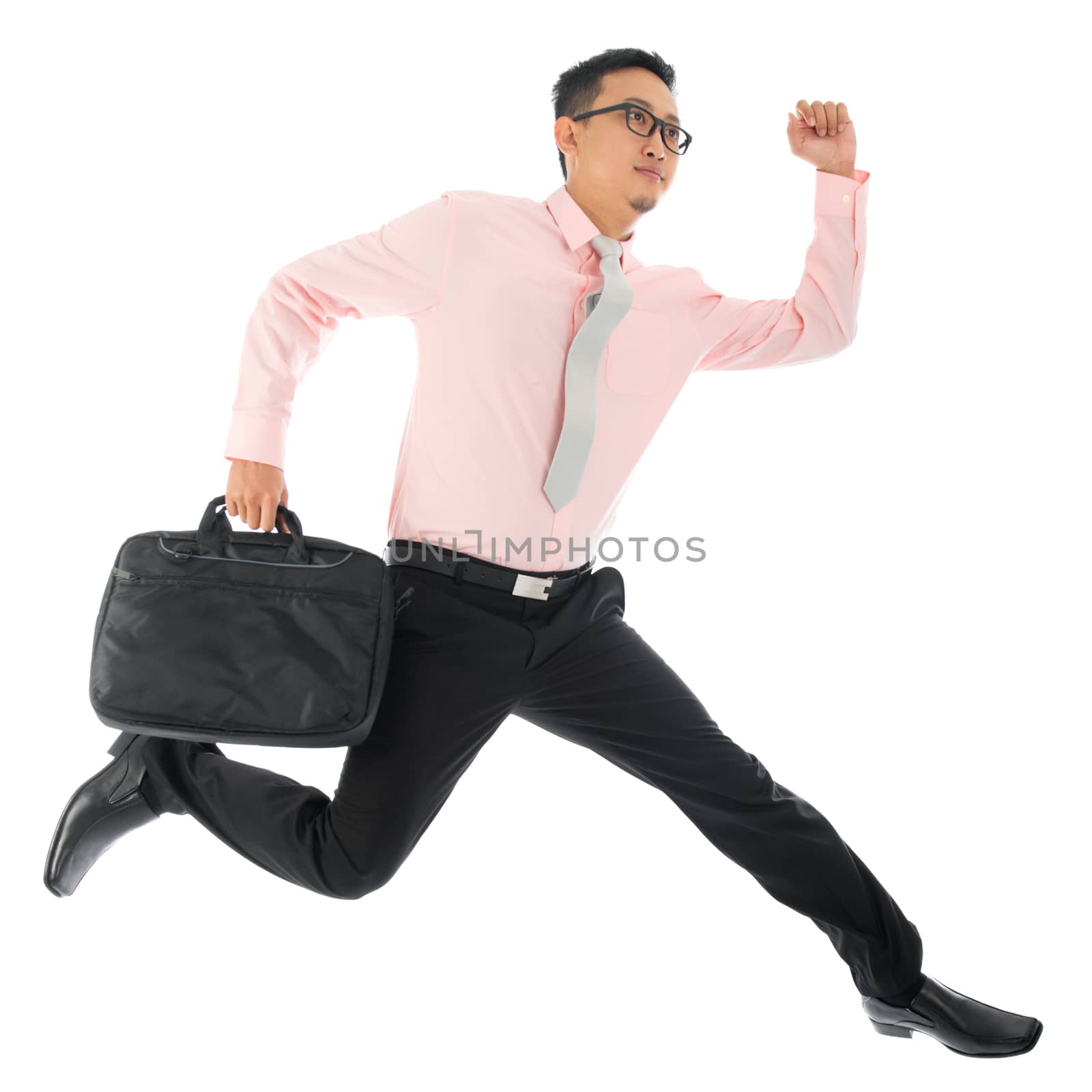 Full body young Asian businessman running or jumping up with a briefcase, isolated on white background