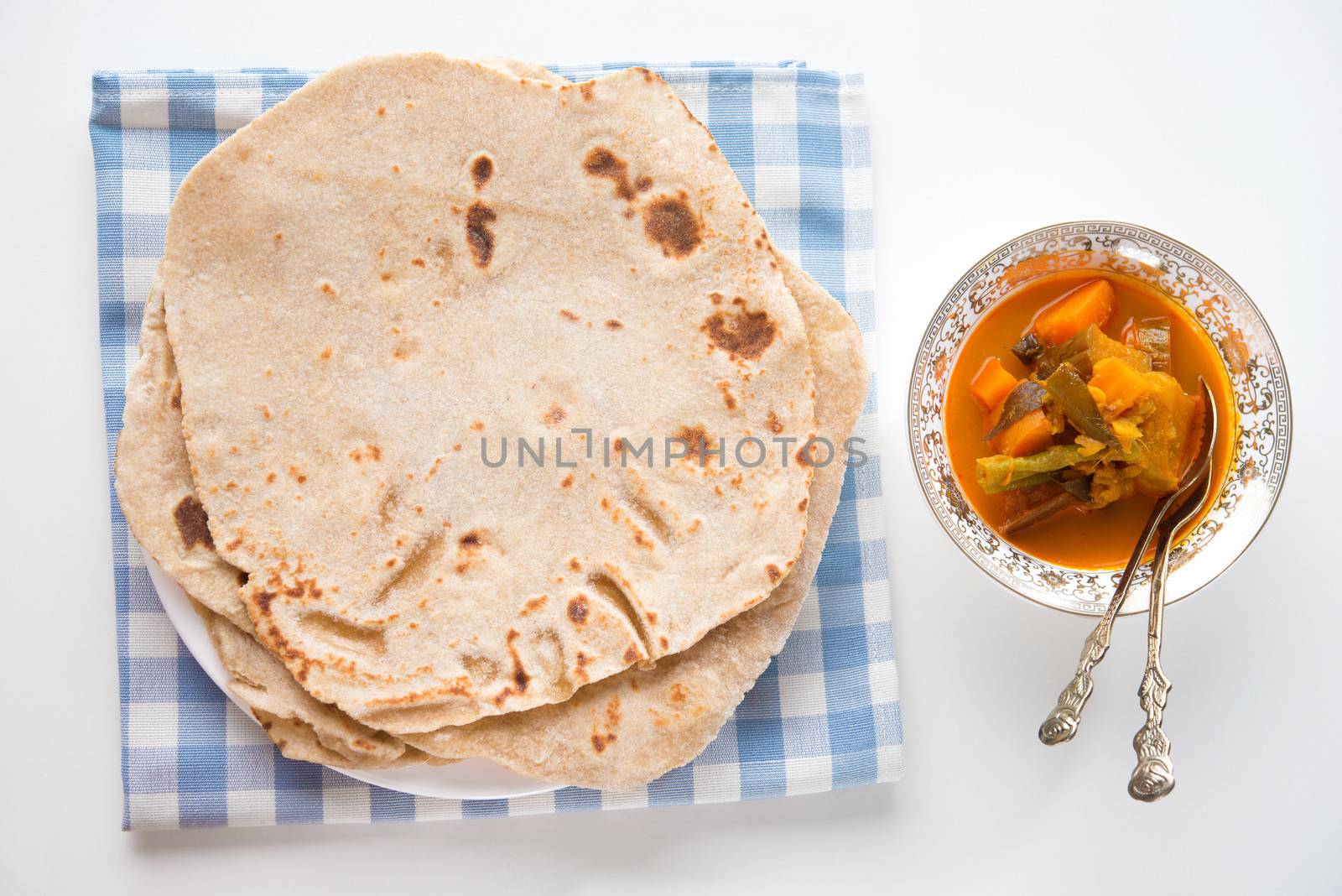 Chapatti roti or Flat bread and curry dahl. Indian food on dining table. 
