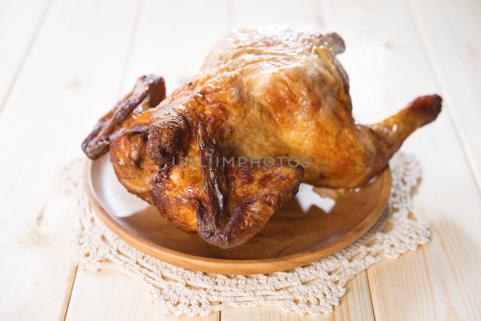 Whole roast chicken on dining table.