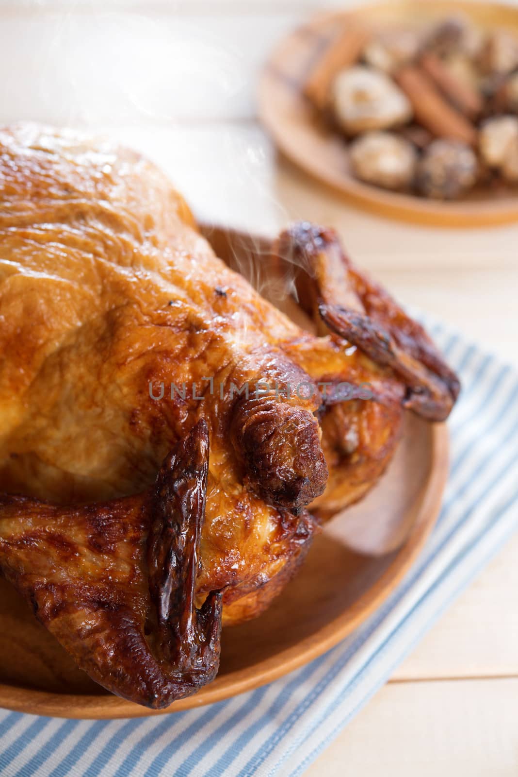 Roast chicken ready to eat on dining table.