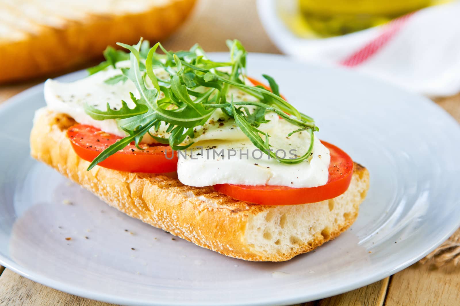 Mozzarella with tomato and rocket sandwich