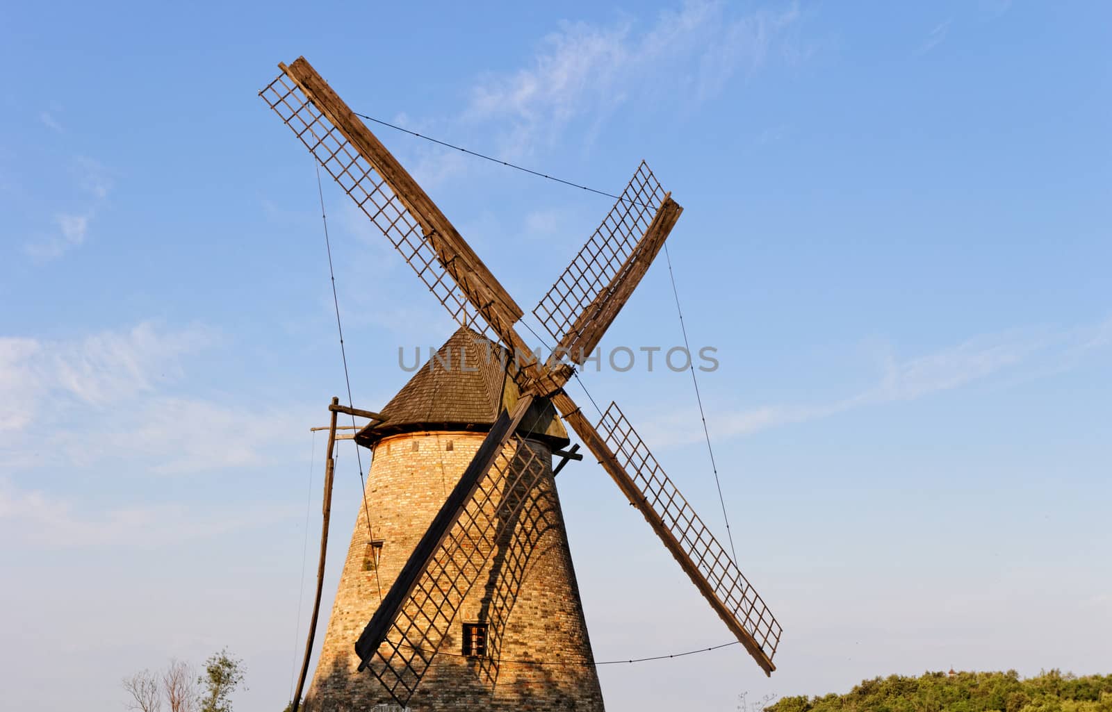 Old wooden windmill against the blue sky