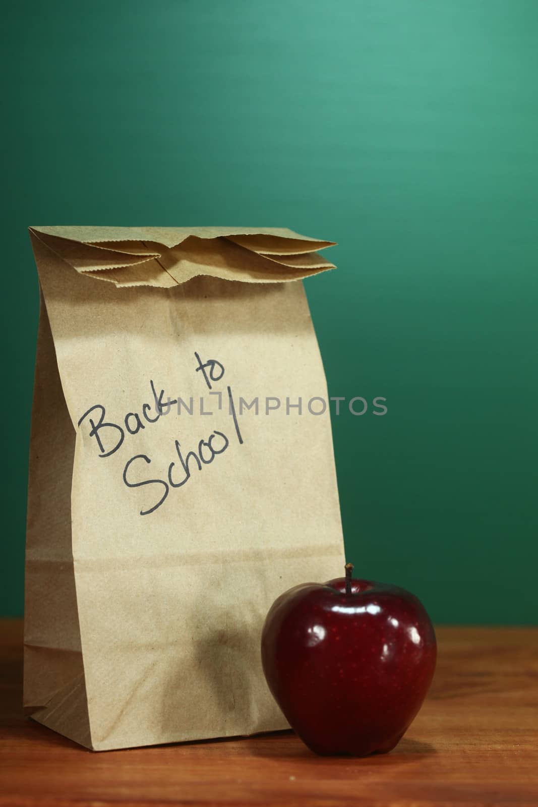 School Lunch Sack Sitting on Teacher Desk by tobkatrina