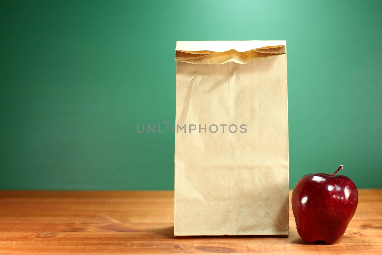 School Lunch Sack Sitting on Teacher Desk by tobkatrina