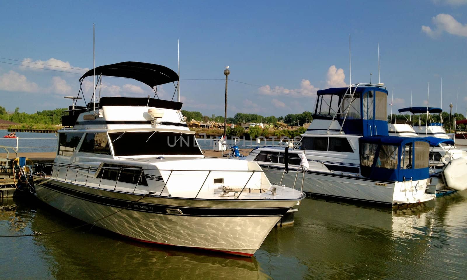 Huron Boats on a Dock by RefocusPhoto