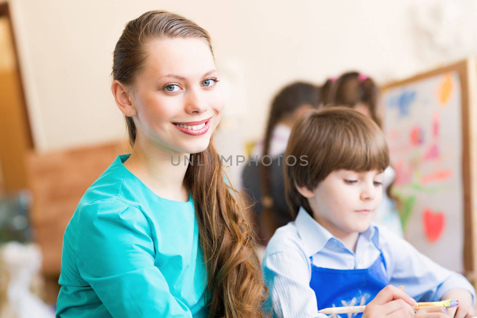 teacher deals with a boy, a drawing lesson