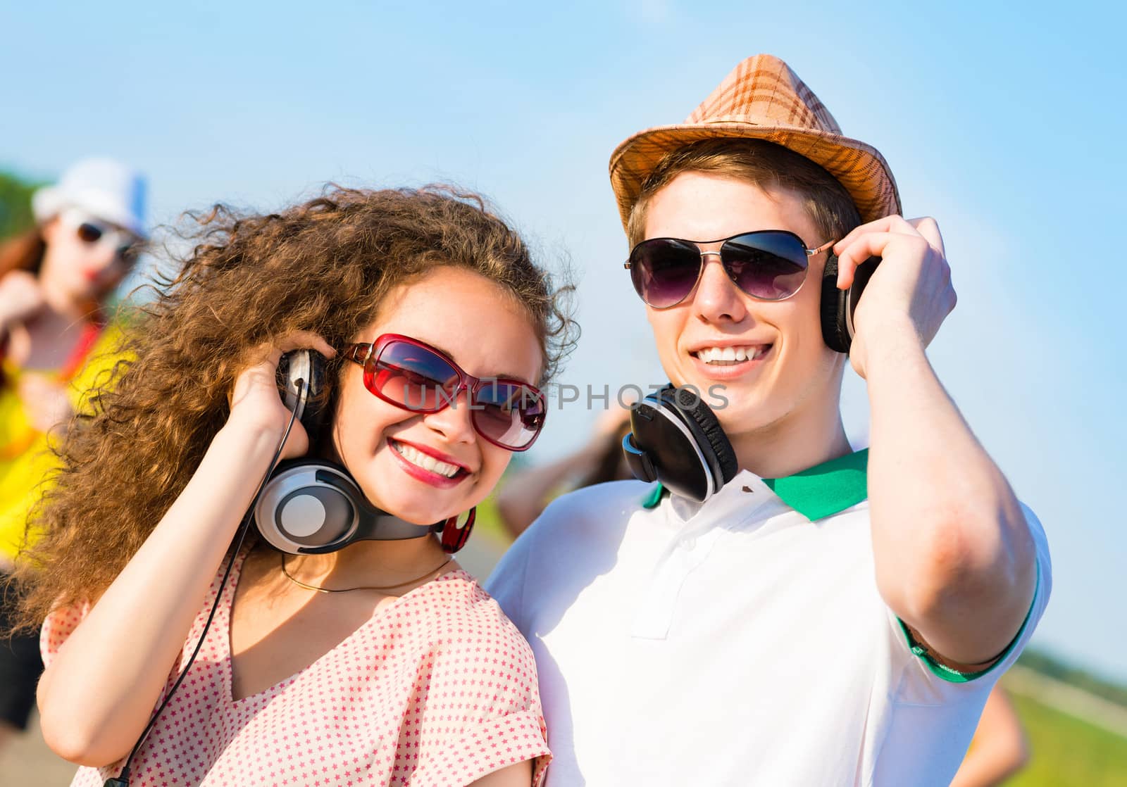 young couple standing on the road, having fun with friends