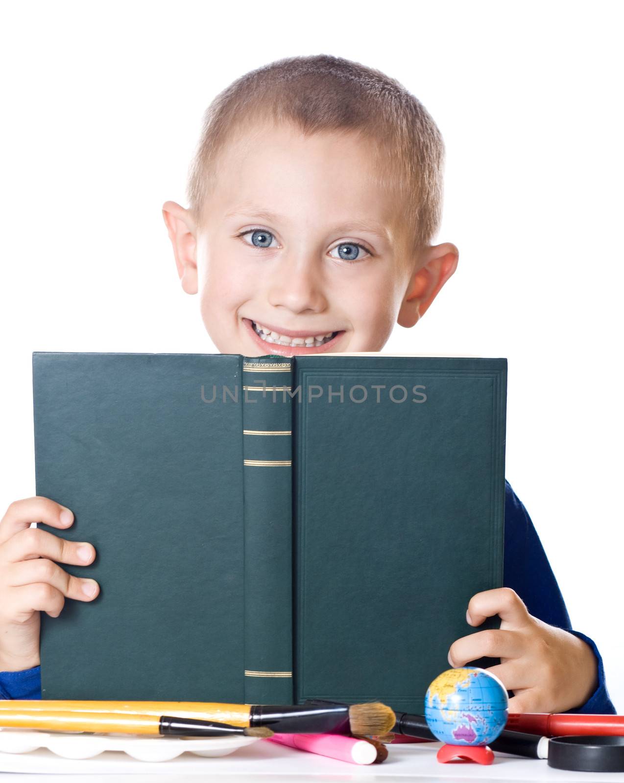 Schoolboy reading a book isolated on white background