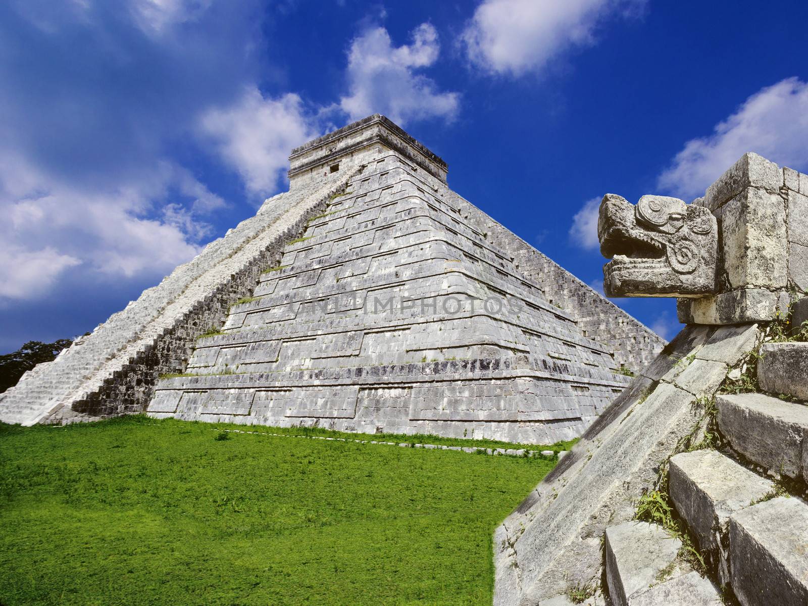 Mayan pyramid at Chichen Itza with stone snake in the foreground. Yucatan,Mexico