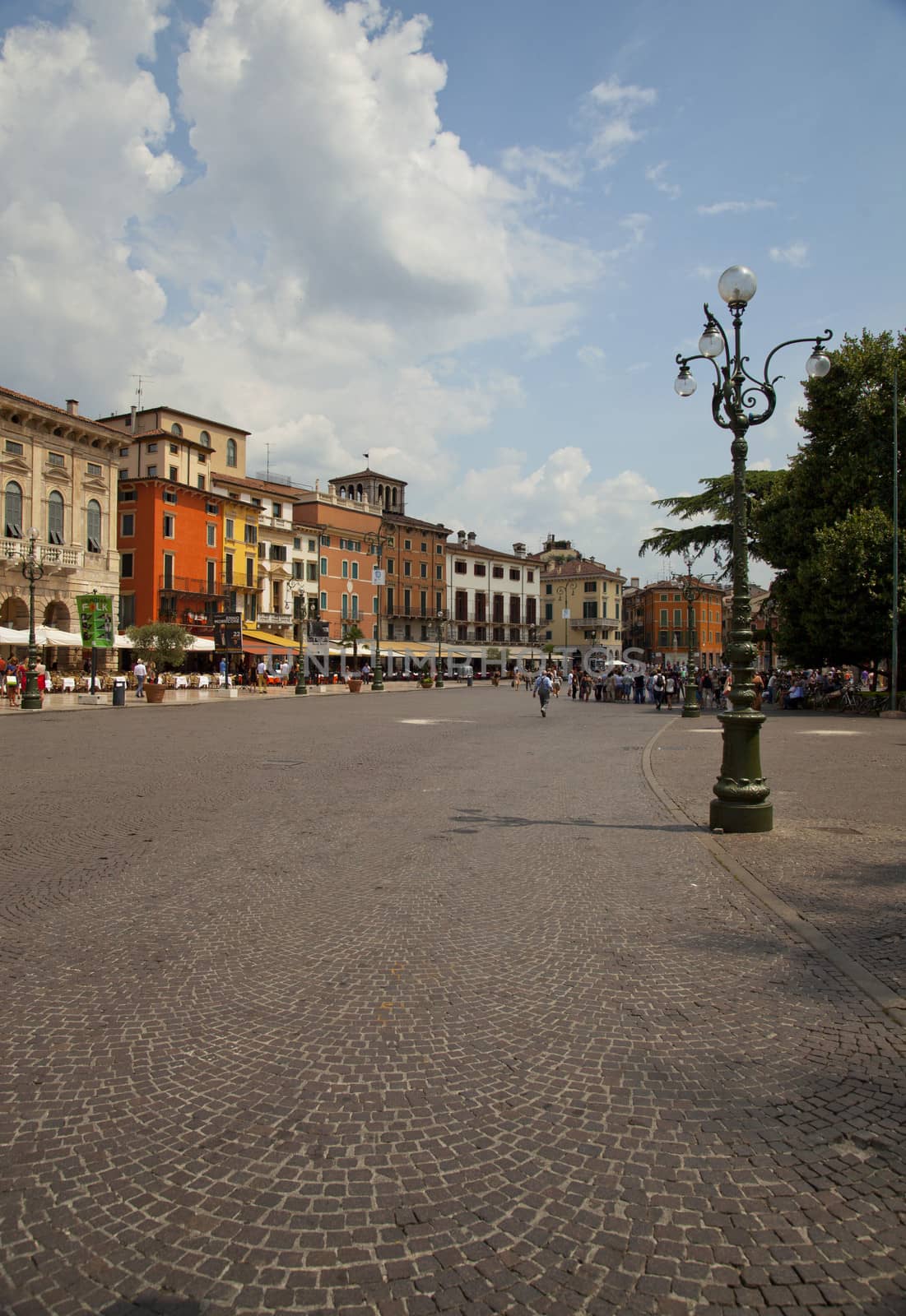 An Italian piazza with multicolour buildings under blue sky