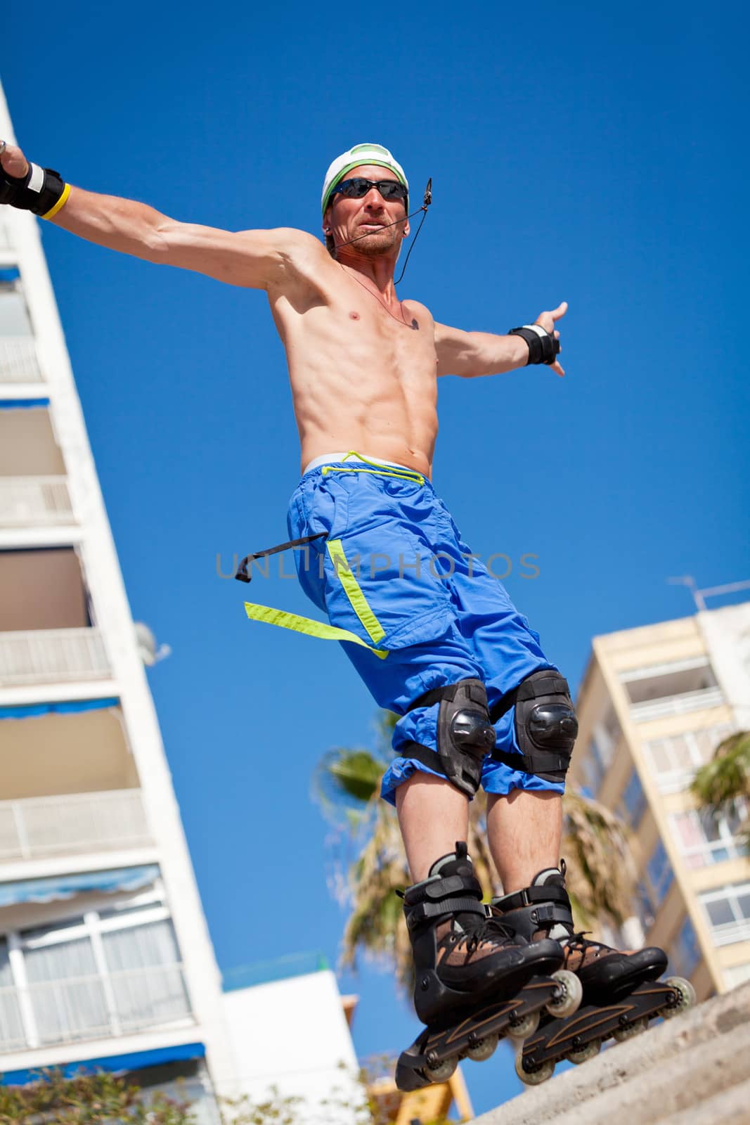 young man with inline skates in summer outdoor rollerblades skater