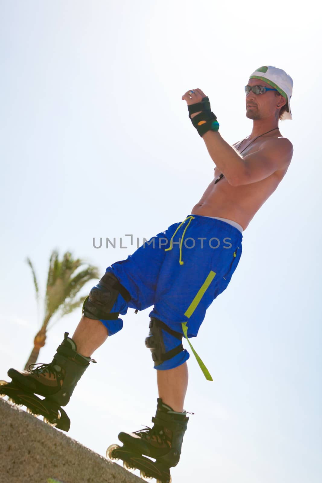 young man with inline skates in summer outdoor rollerblades skater