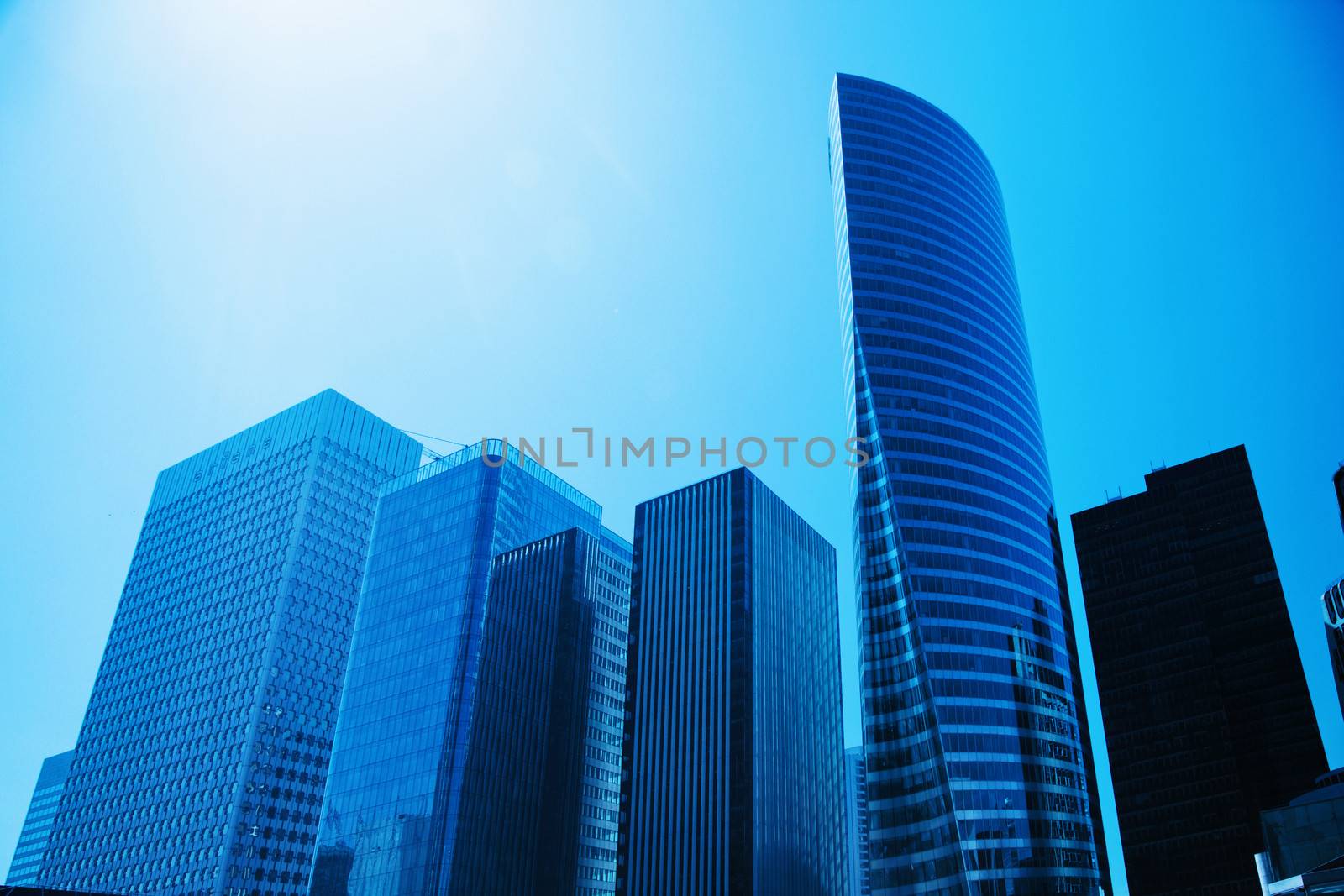 Business skyscrapers, sunny blue sky. La Defense financial district in Paris, France.