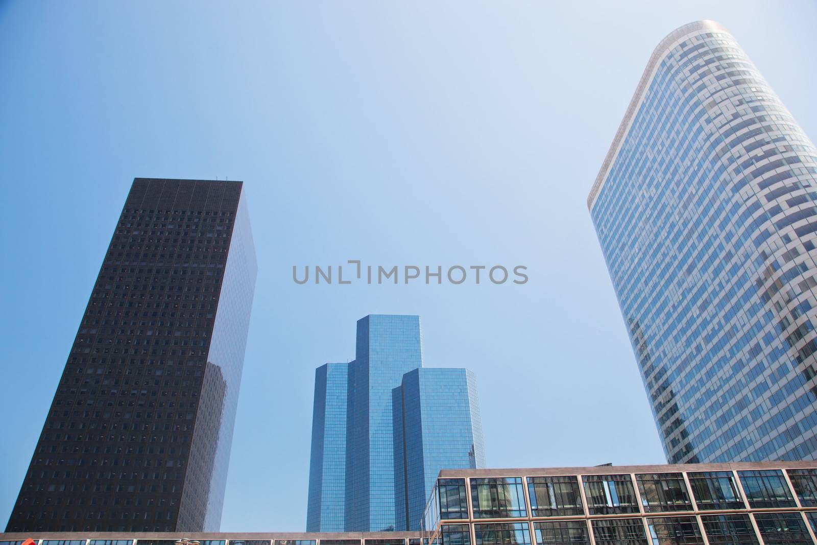 Business skyscrapers, sunny blue sky. La Defense financial district in Paris, France.