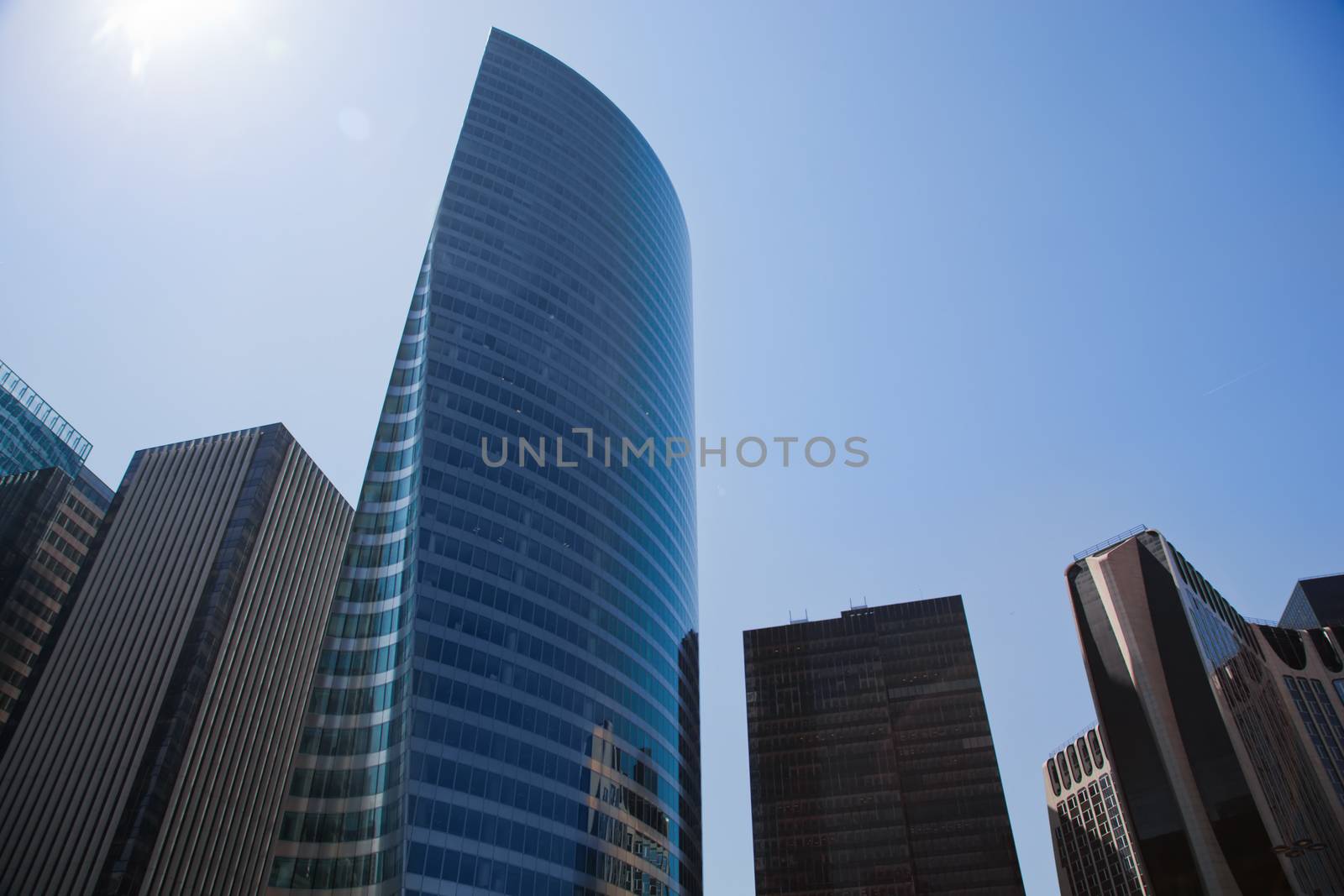 Business skyscrapers, sunny blue sky. La Defense financial district in Paris, France.