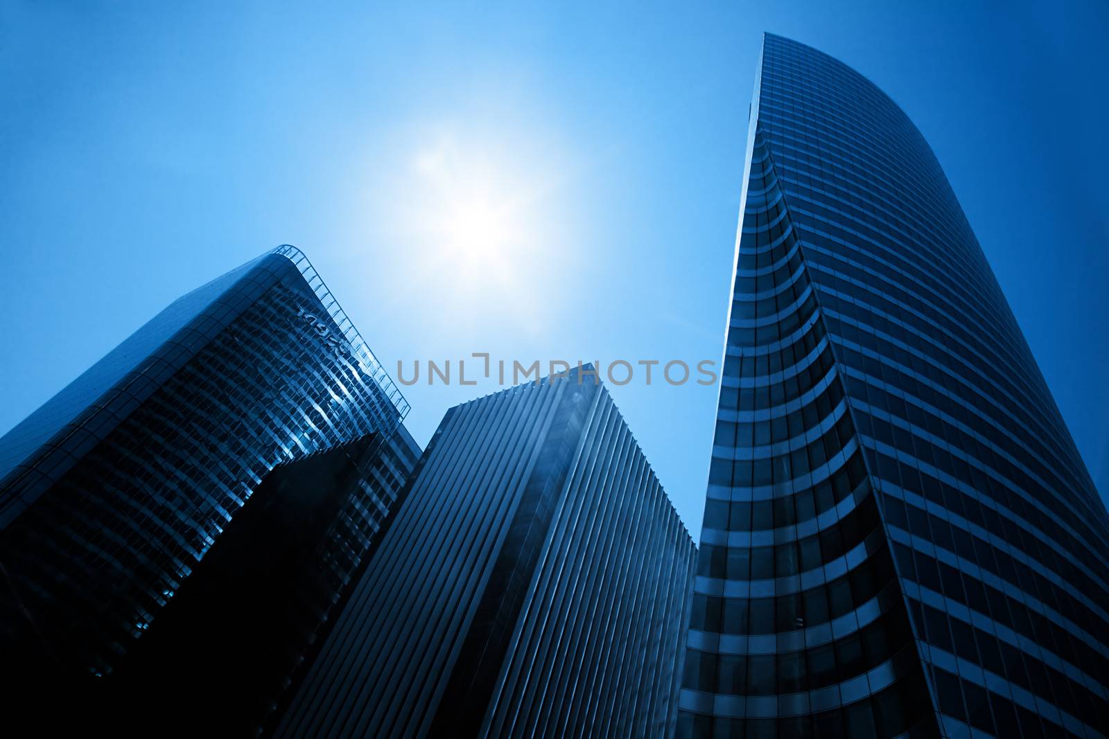 Business skyscrapers, sunny blue sky. La Defense financial district in Paris, France.