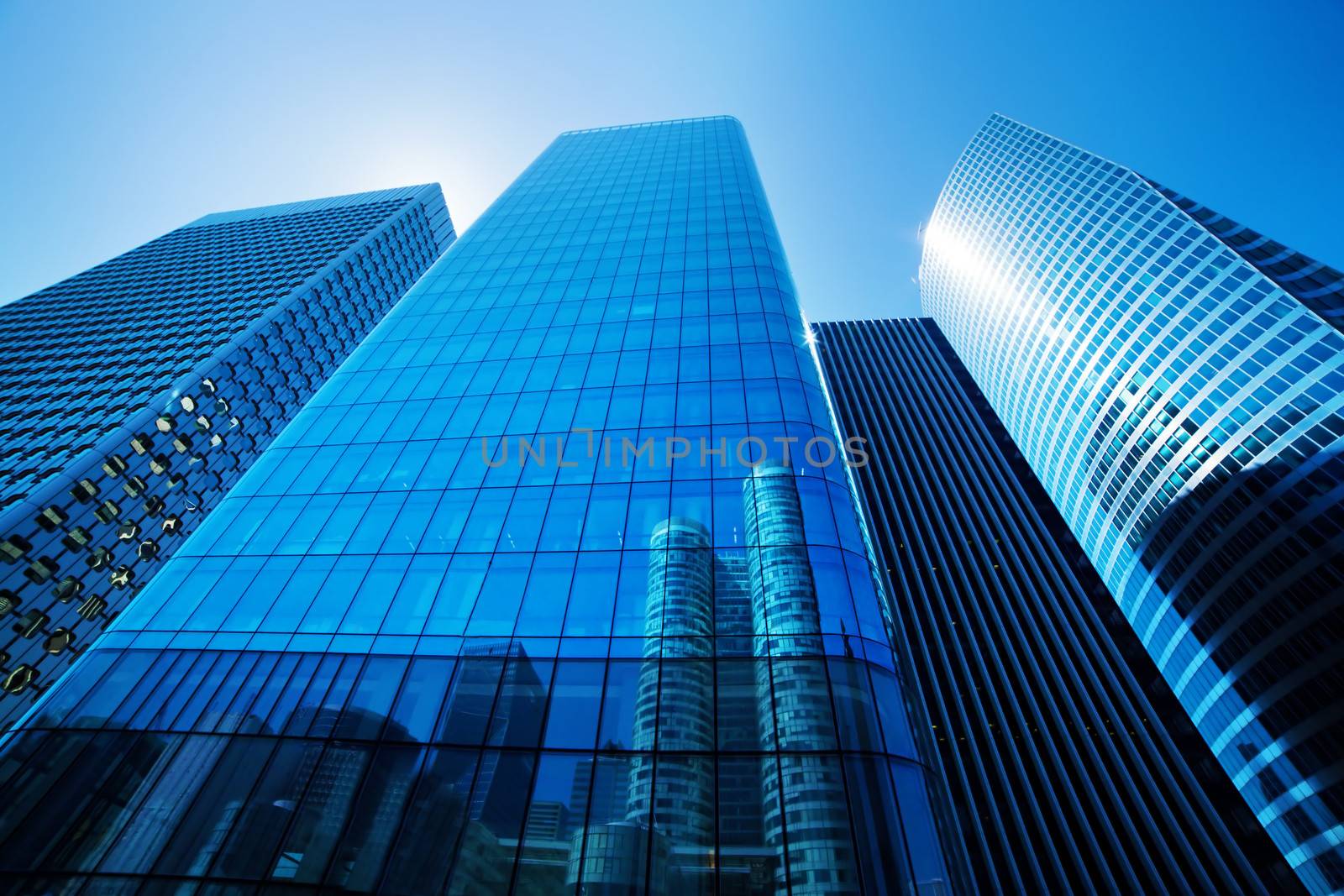 Business skyscrapers, sunny blue sky. La Defense financial district in Paris, France.