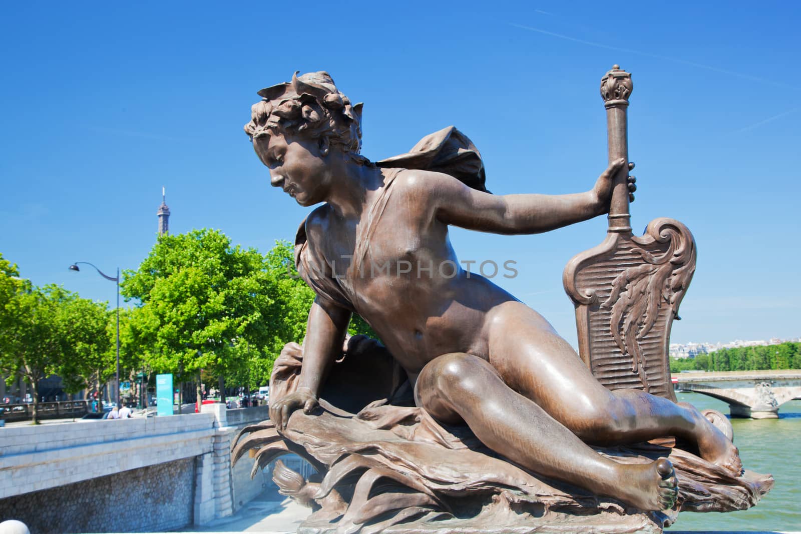 Artistic statue on Alexandre Bridge conceptually looking at Eiffel Tower, Paris, France.