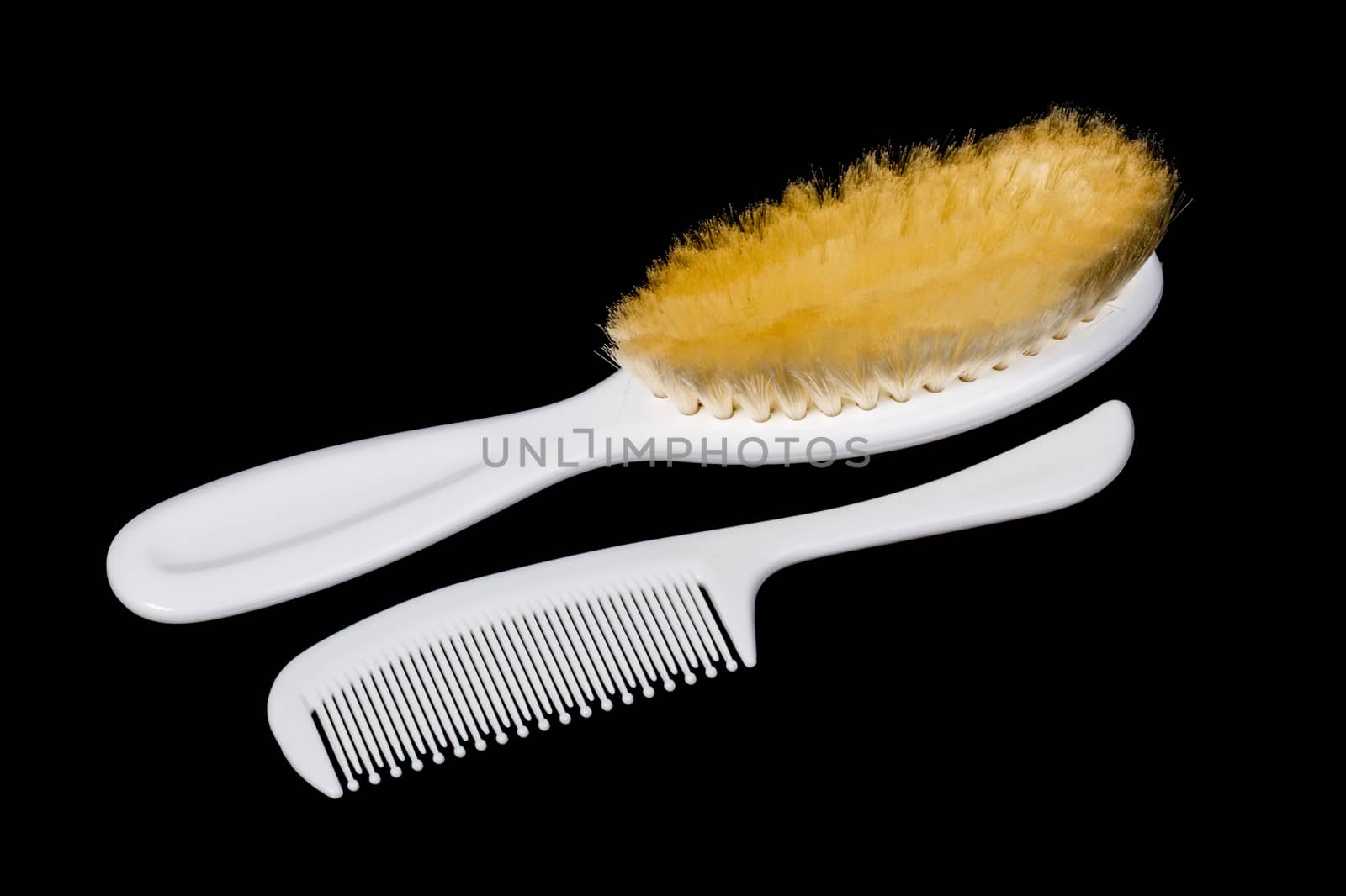 Two white hairbrushes on black background 