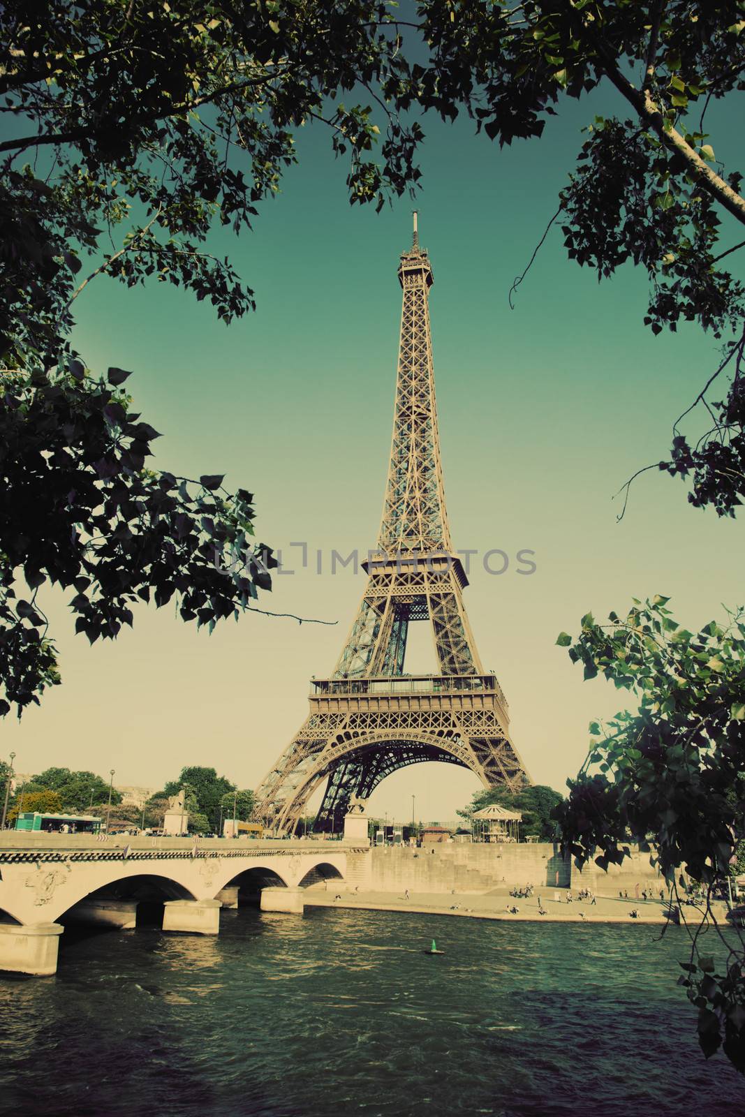 Eiffel Tower and bridge on Seine river in Paris, France. Vintage retro style