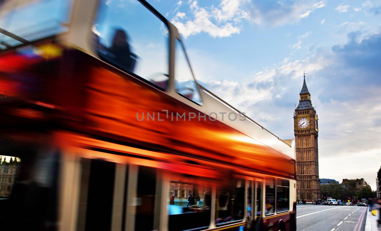 London, the UK. Red bus in motion and Big Ben, the Palace of Westminster. The icons of England