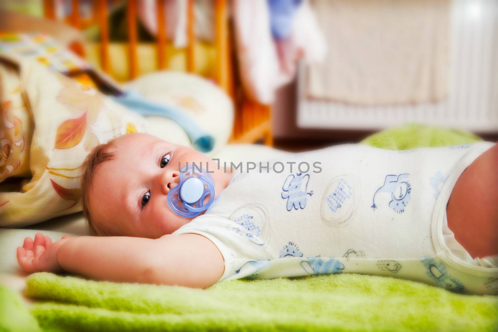 A baby waiting for changing his napkin by photocreo