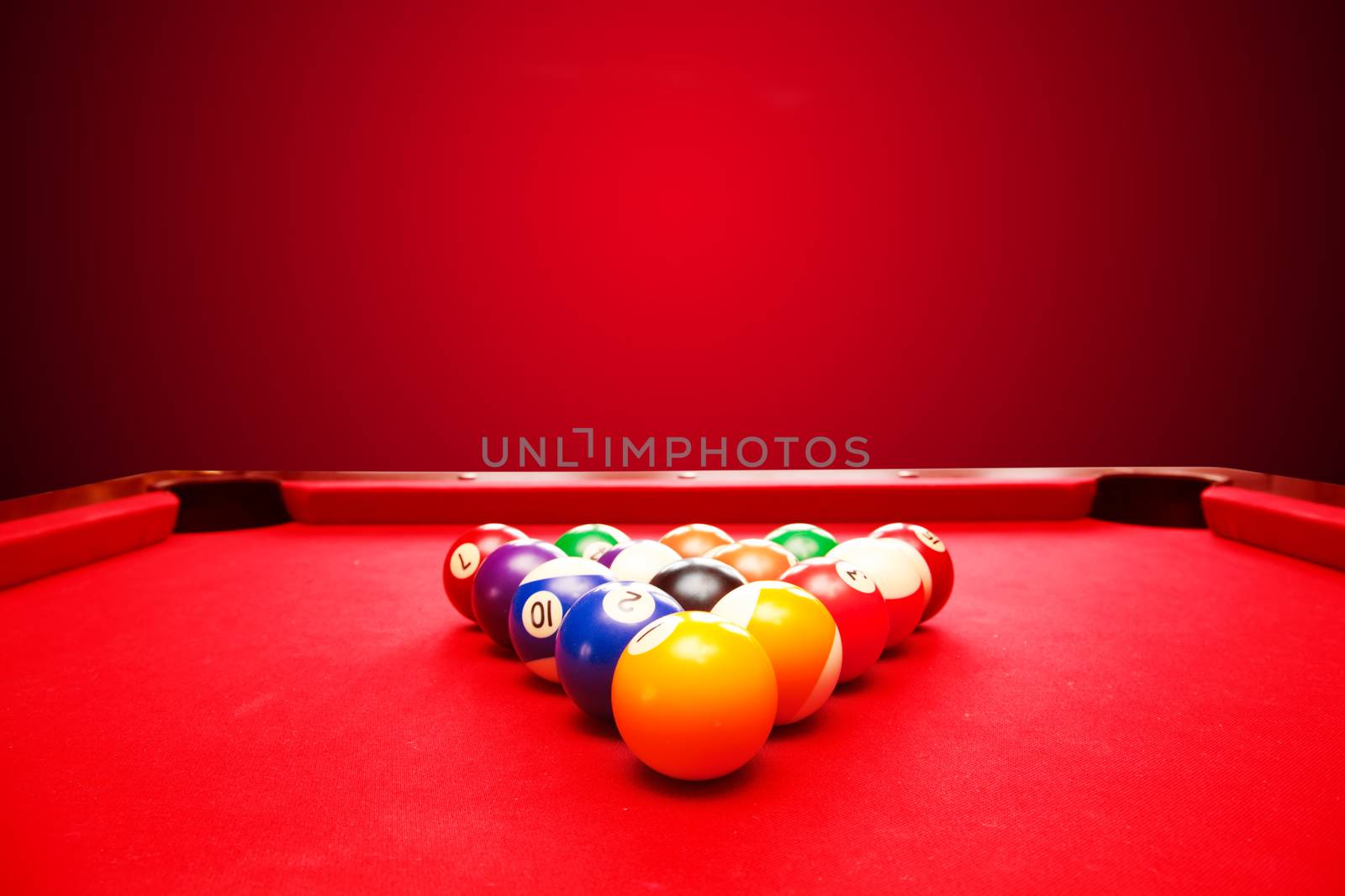 Billards pool game. Color balls in triangle. Red cloth table