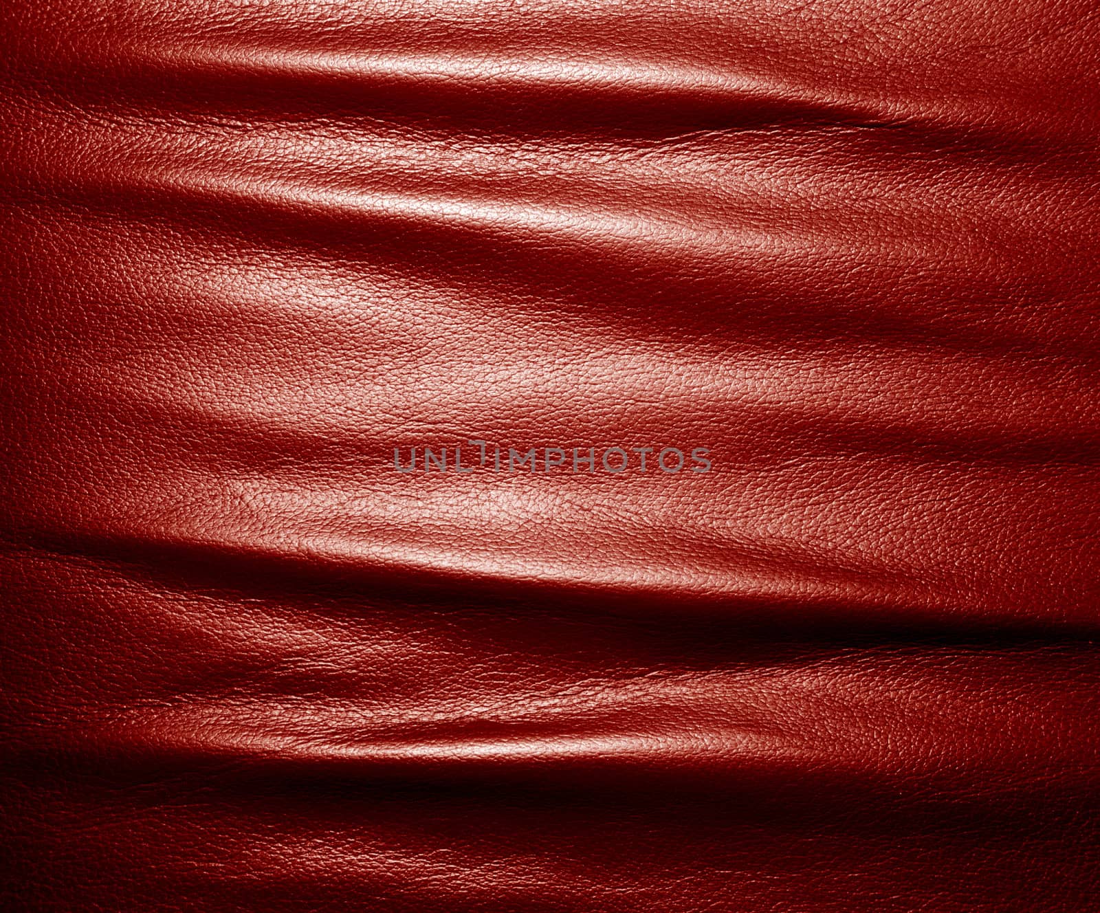 Soft wrinkled red leather. Texture or background with copyspace, high resolution