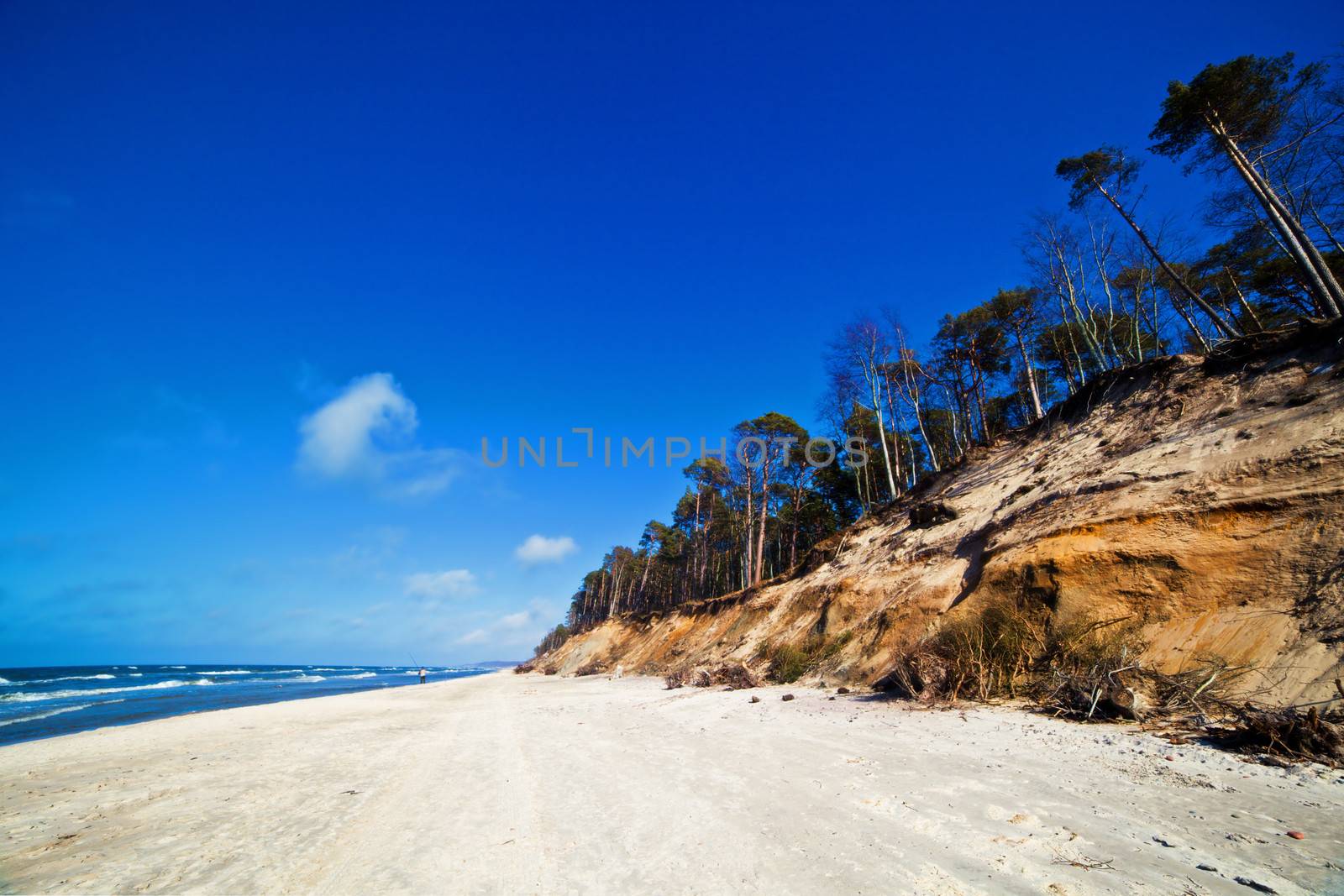 Cliffs on a sunny beach by photocreo
