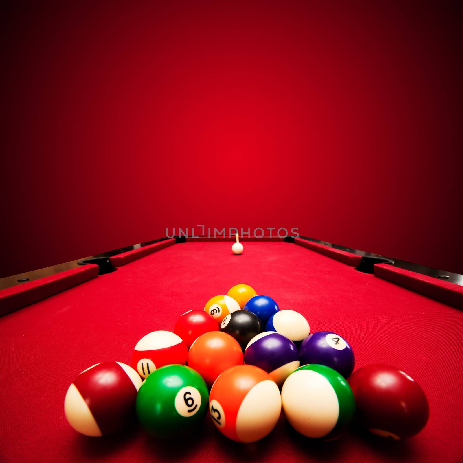 Billards pool game. Color balls in triangle, aiming at cue ball by photocreo