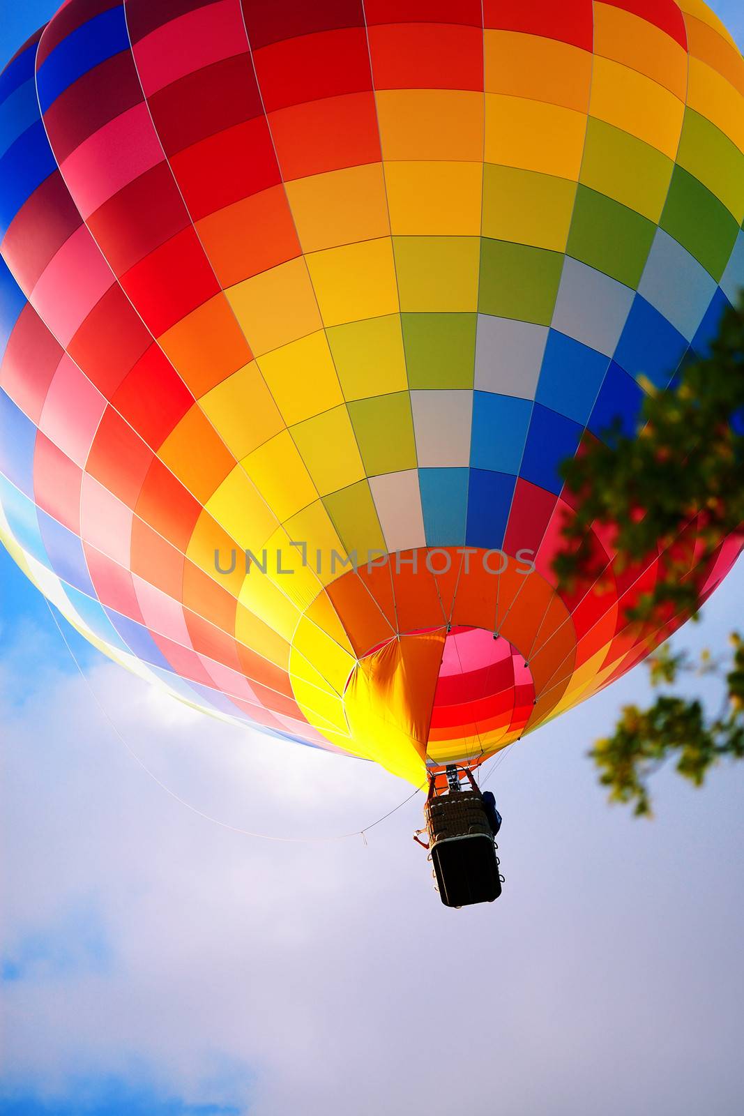 Raznouvetny balloon in clouds. Balloon in the sky. Flight by a balloon.