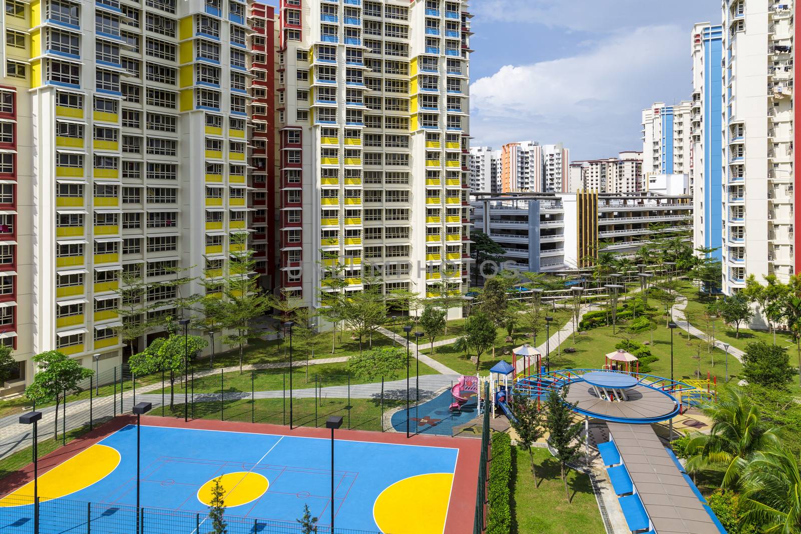 A new apartment neighborhood with carpark and playground.