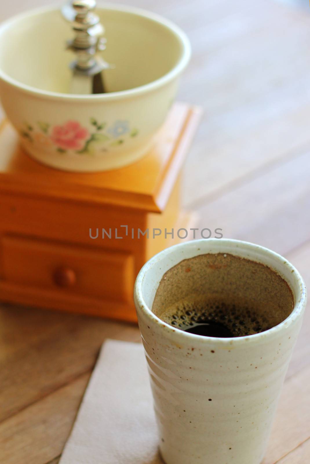 Black coffee with vintage coffee grinder