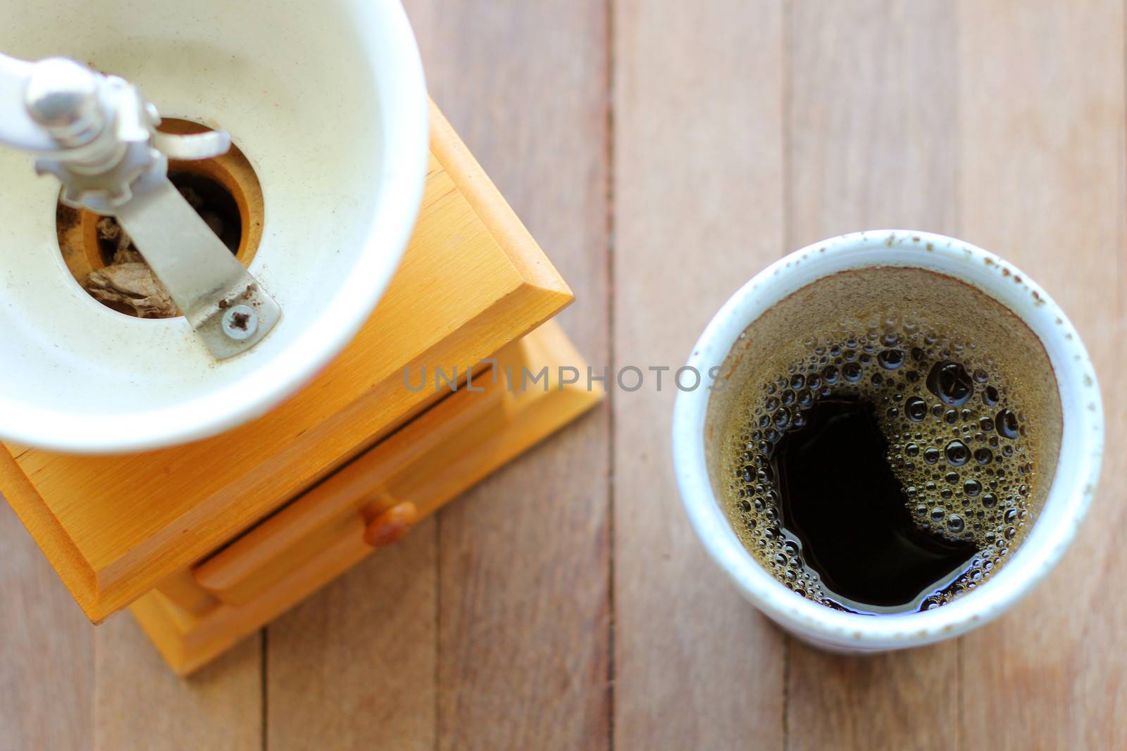 Black coffee with vintage coffee grinder by nuchylee
