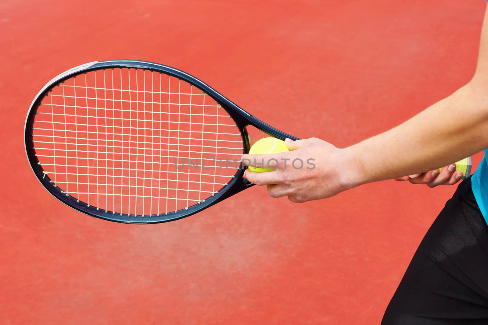 Player on hard court ready to serve the tennis ball with racket