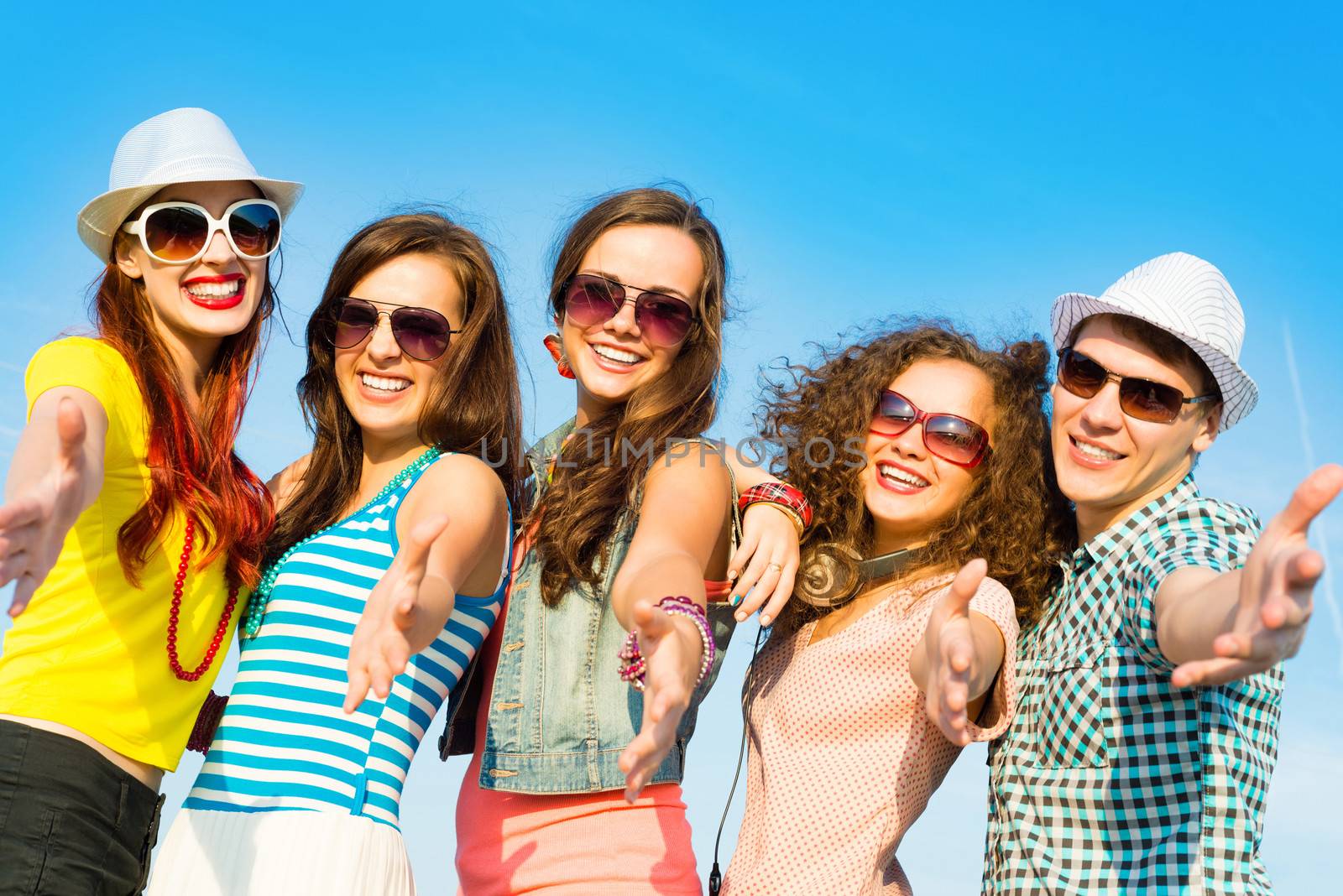 group of young people wearing sunglasses and hats hugging and standing in a row, spending time with friends