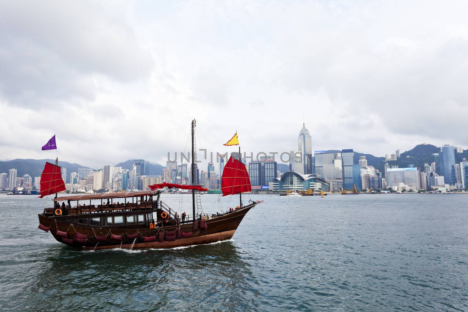 Hong Kong harbor with tourist junk boat